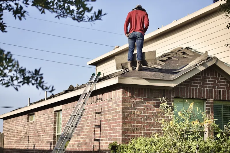Professional roofer working on a residential roof in Dogwood Trails